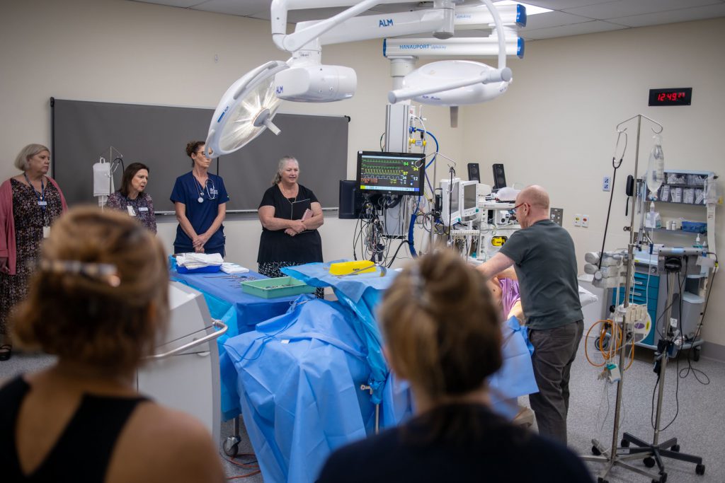 Kim Heaslip (in grey shirt, right) demonstrating a caesarean section setup at CSDS.